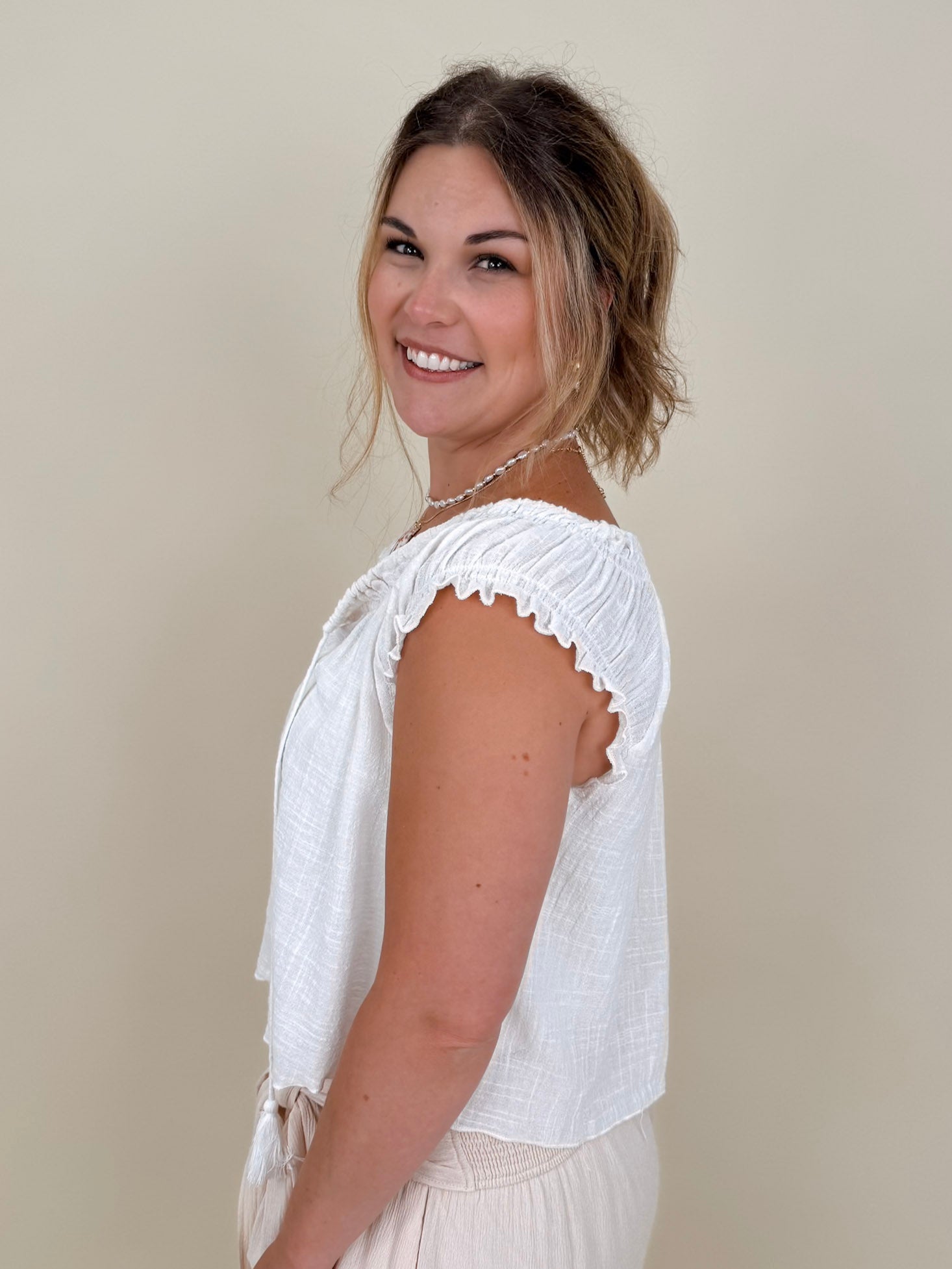 Hadleigh Smocked Neckline Blouse in white with tie neckline and flutter sleeves — Paper Doll