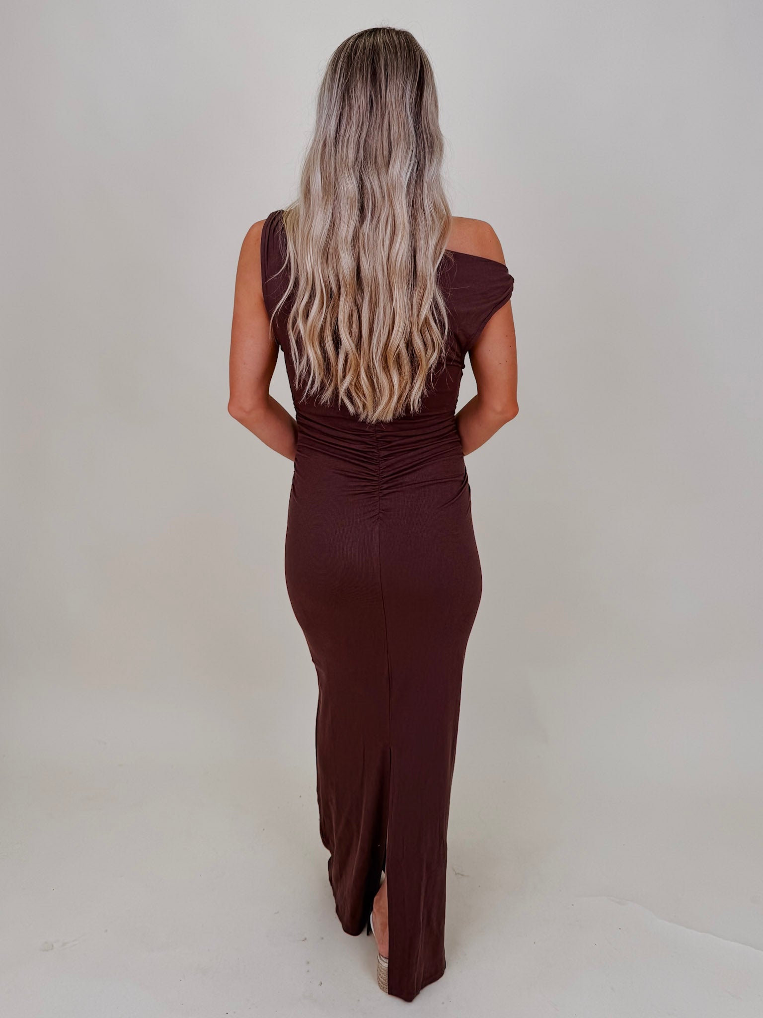 Natalie Ruched Maxi Dress in chocolate brown with asymmetric neckline and ruched waist — Paper Doll