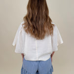 Kira Smocked Shorts in light denim blue with smocked waist and tiered ruffle hem — Paper Doll
