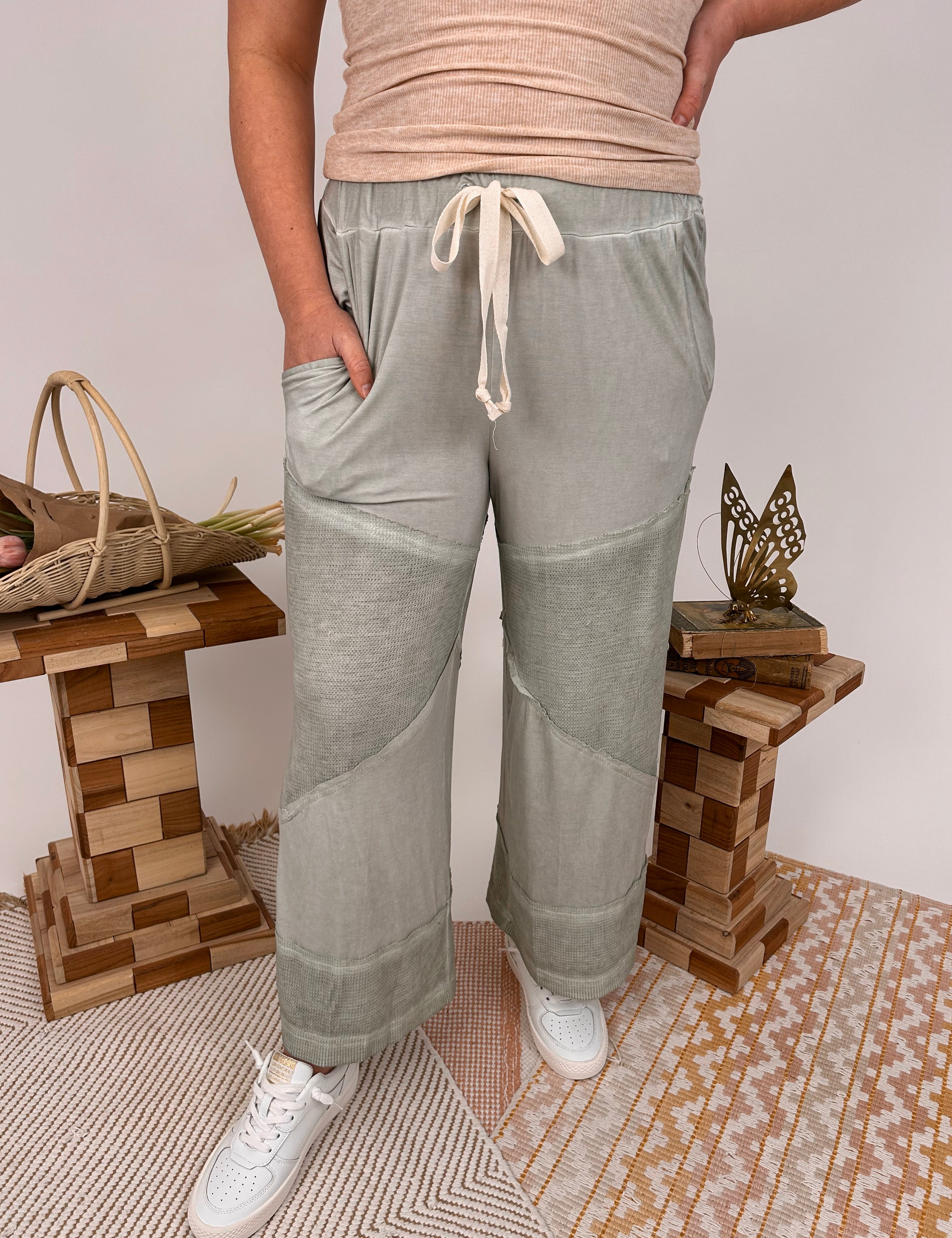 Woman wearing sage green Annalise Cropped Soft Knit Pant with textured knit panels at knees and hem, drawstring waist, and relaxed fit
