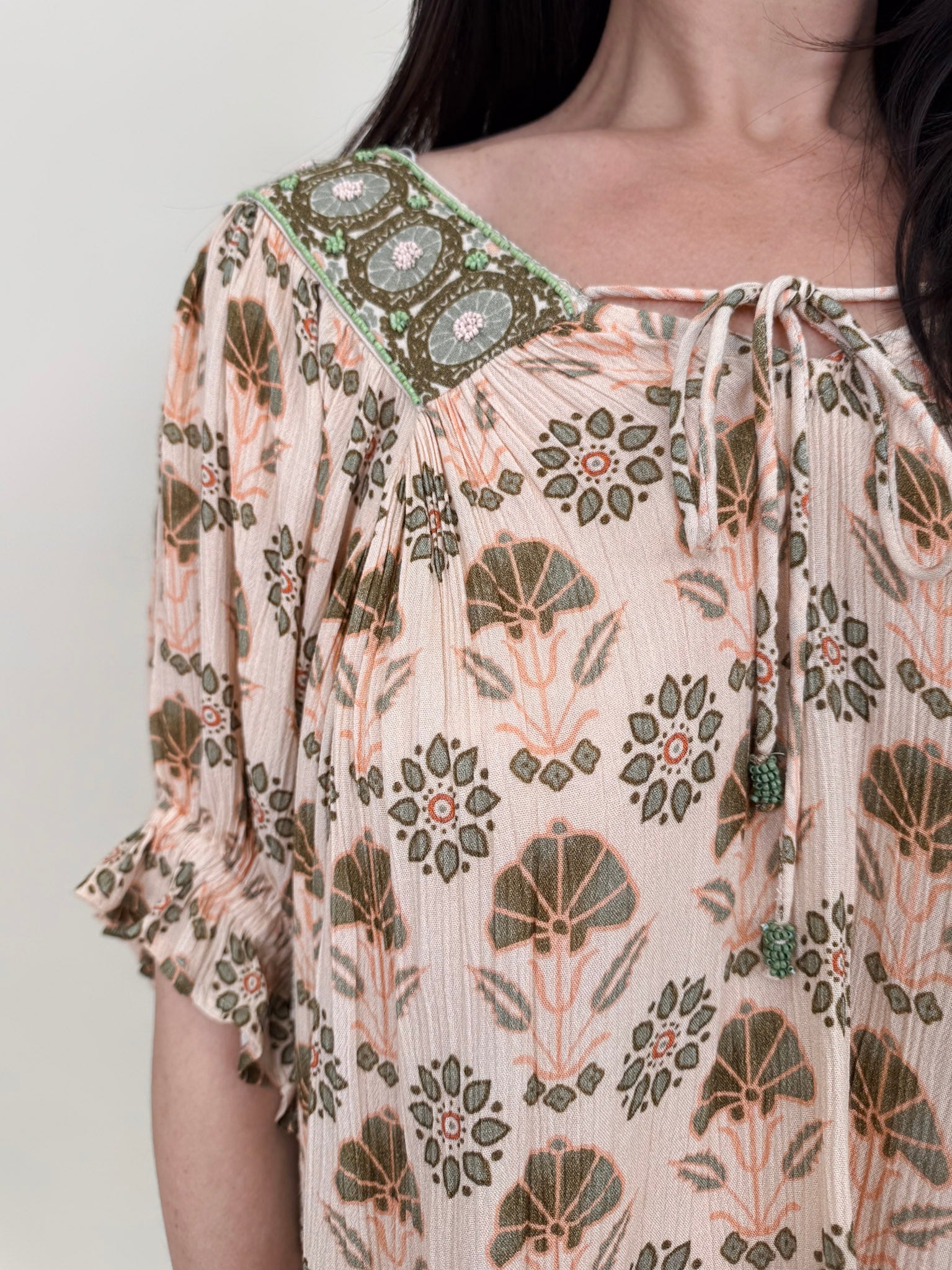Kace Floral Boho Blouse in cream botanical print with embroidered yoke and smocked ruffle sleeves — Paper Doll
