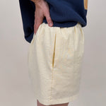 The Sunshine Shorts in lemon and white stripe seersucker with elastic waist and side pockets — Paper Doll