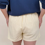 The Sunshine Shorts in lemon and white stripe seersucker with elastic waist and side pockets — Paper Doll