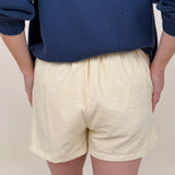 The Sunshine Shorts in lemon and white stripe seersucker with elastic waist and side pockets — Paper Doll