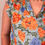 Close-up of a floral dress with orange and blue flowers on a light background