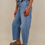 The Lovely Jean in light vintage wash denim with high rise barrel leg and raw hem — Paper Doll