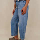 The Lovely Jean in light vintage wash denim with high rise barrel leg and raw hem — Paper Doll