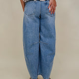 The Lovely Jean in light vintage wash denim with high rise barrel leg and raw hem — Paper Doll