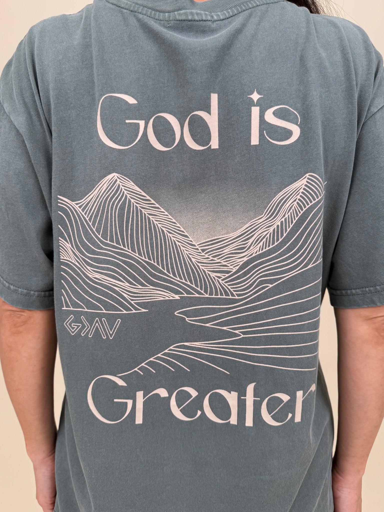 God Is Greater Unisex Tee in washed slate with mountain graphic on back — Paper Doll