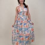 Off To Kokomo Maxi Dress in beige multi stamp print with halter neckline and open back bow — Paper Doll
