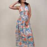 Off To Kokomo Maxi Dress in beige multi stamp print with halter neckline and open back bow — Paper Doll
