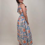 Off To Kokomo Maxi Dress in beige multi stamp print with halter neckline and open back bow — Paper Doll
