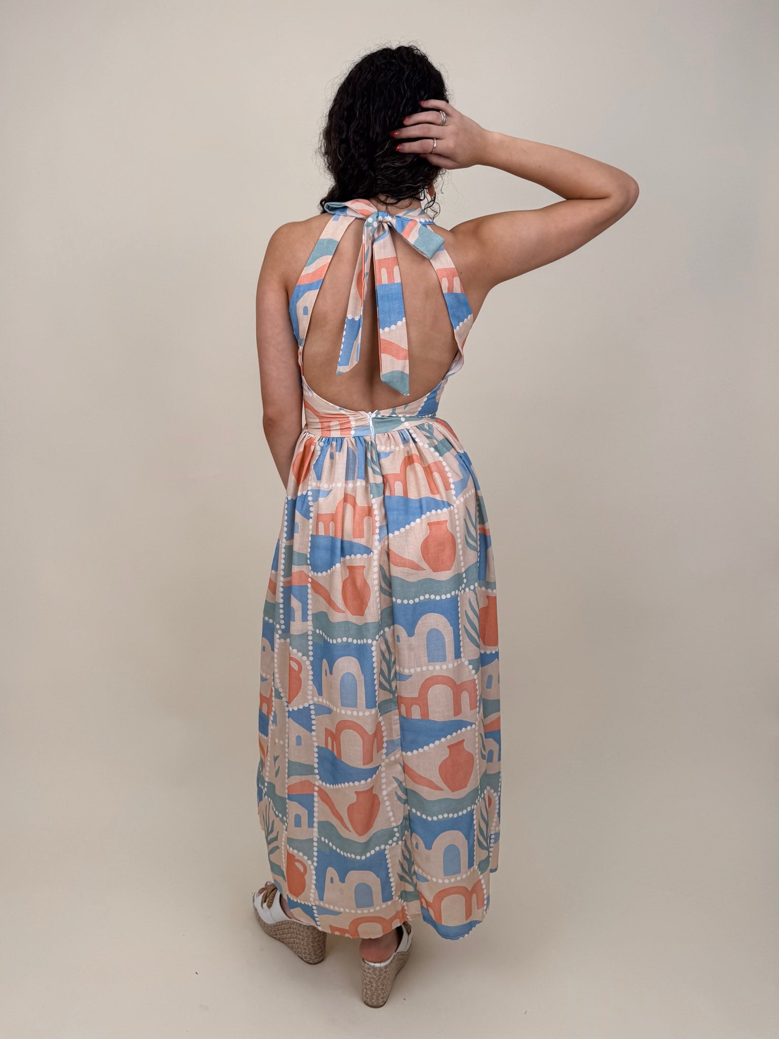 Off To Kokomo Maxi Dress in beige multi stamp print with halter neckline and open back bow — Paper Doll
