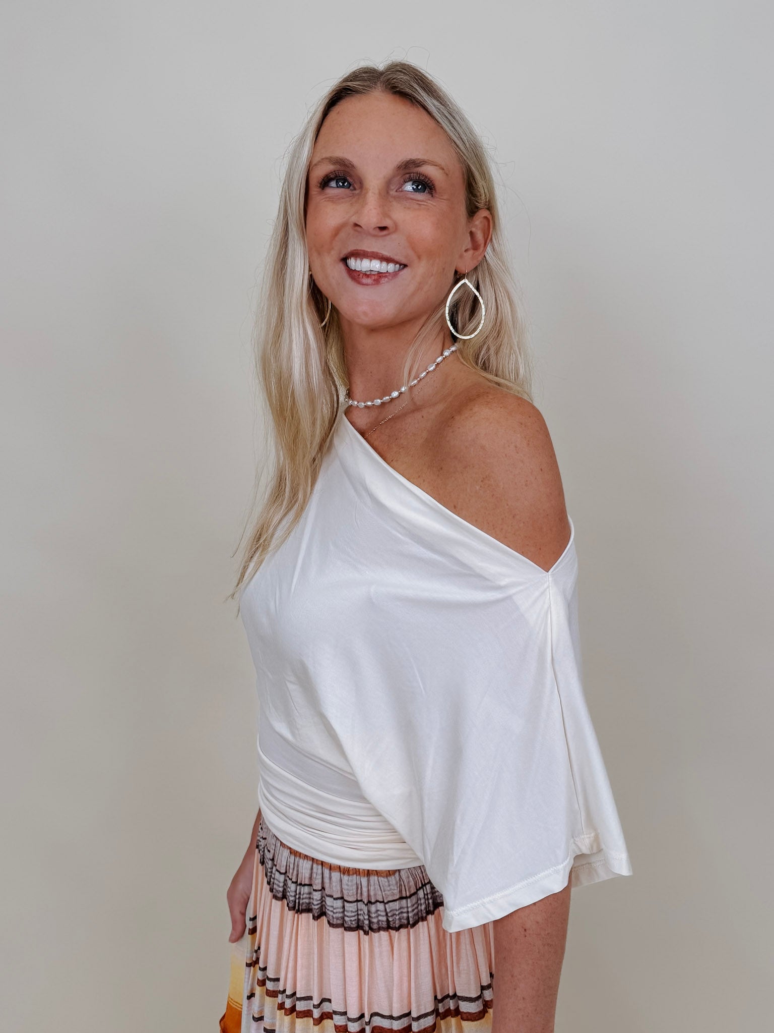 Tara Draped Sleeve Blouse in cream with an off-shoulder neckline and draped sleeves — Paper Doll
