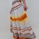 Sunset Tiered Maxi Skirt in an ombré sunset stripe of peach, gold, and rust — Paper Doll
