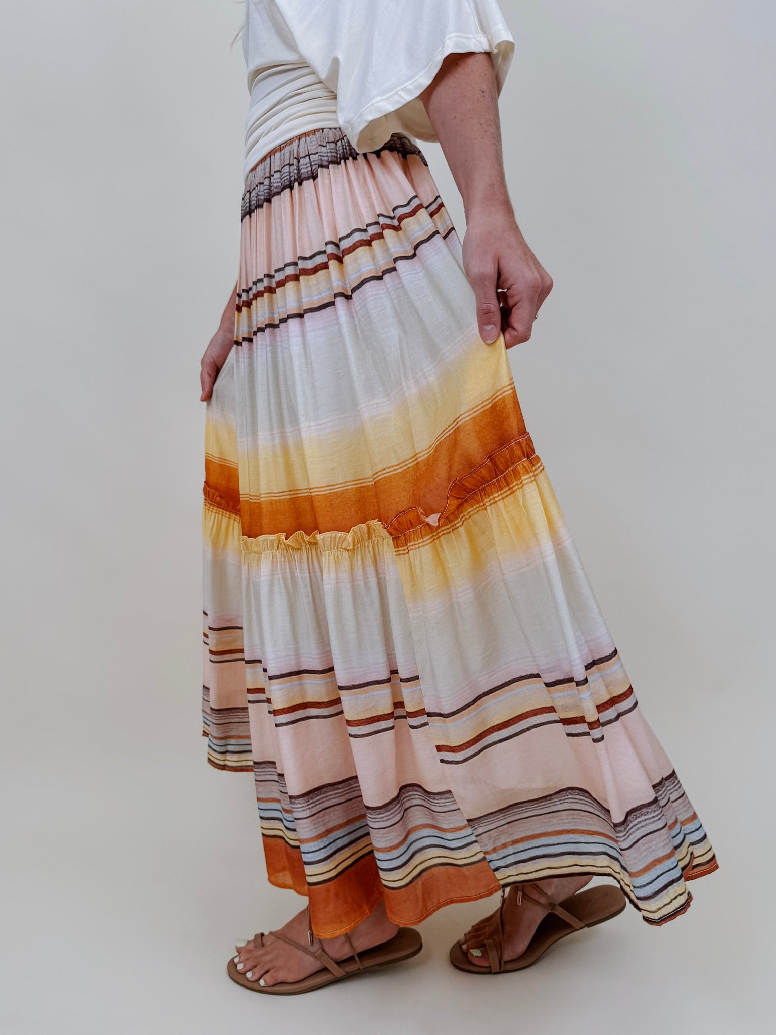 Sunset Tiered Maxi Skirt in an ombré sunset stripe of peach, gold, and rust — Paper Doll
