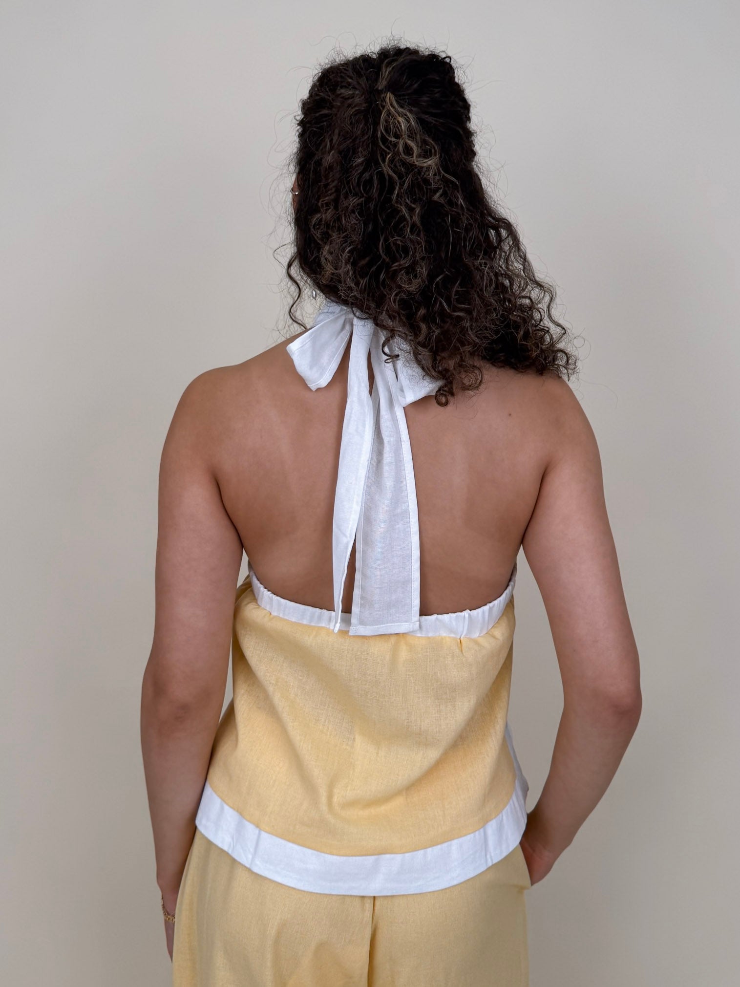 Walking At Sunset Top in lemon yellow with cross-halter neckline and white contrast trim — Paper Doll
