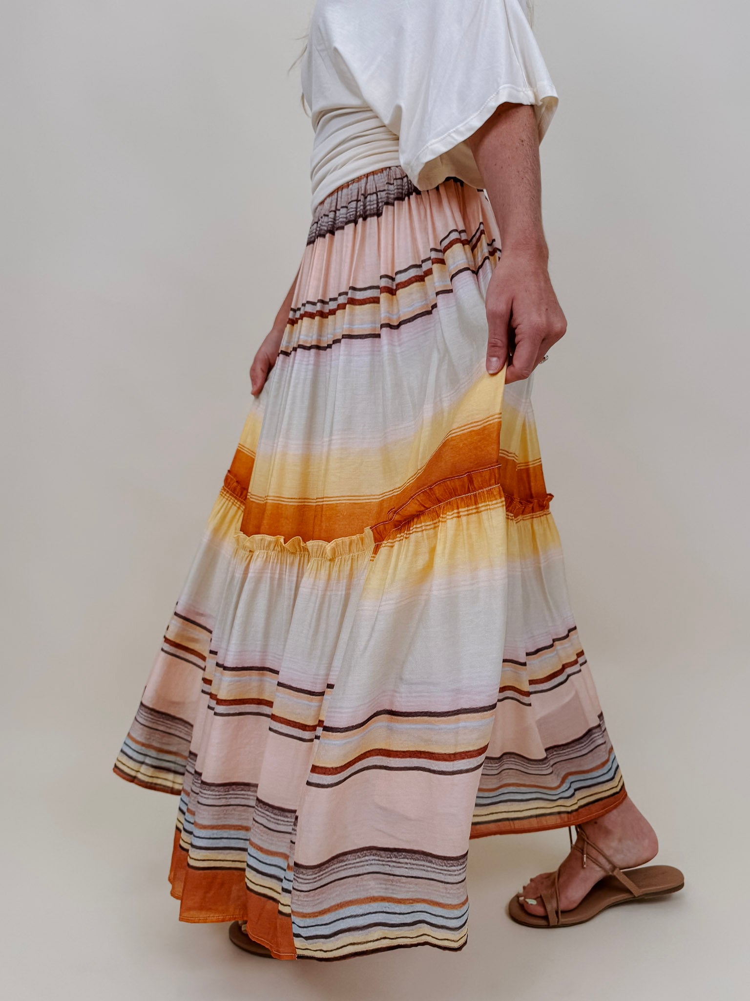 Sunset Tiered Maxi Skirt in an ombré sunset stripe of peach, gold, and rust — Paper Doll
