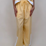 Walking At Sunset Top in lemon yellow with cross-halter neckline and white contrast trim — Paper Doll

