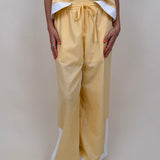 Walking At Sunset Top in lemon yellow with cross-halter neckline and white contrast trim — Paper Doll

