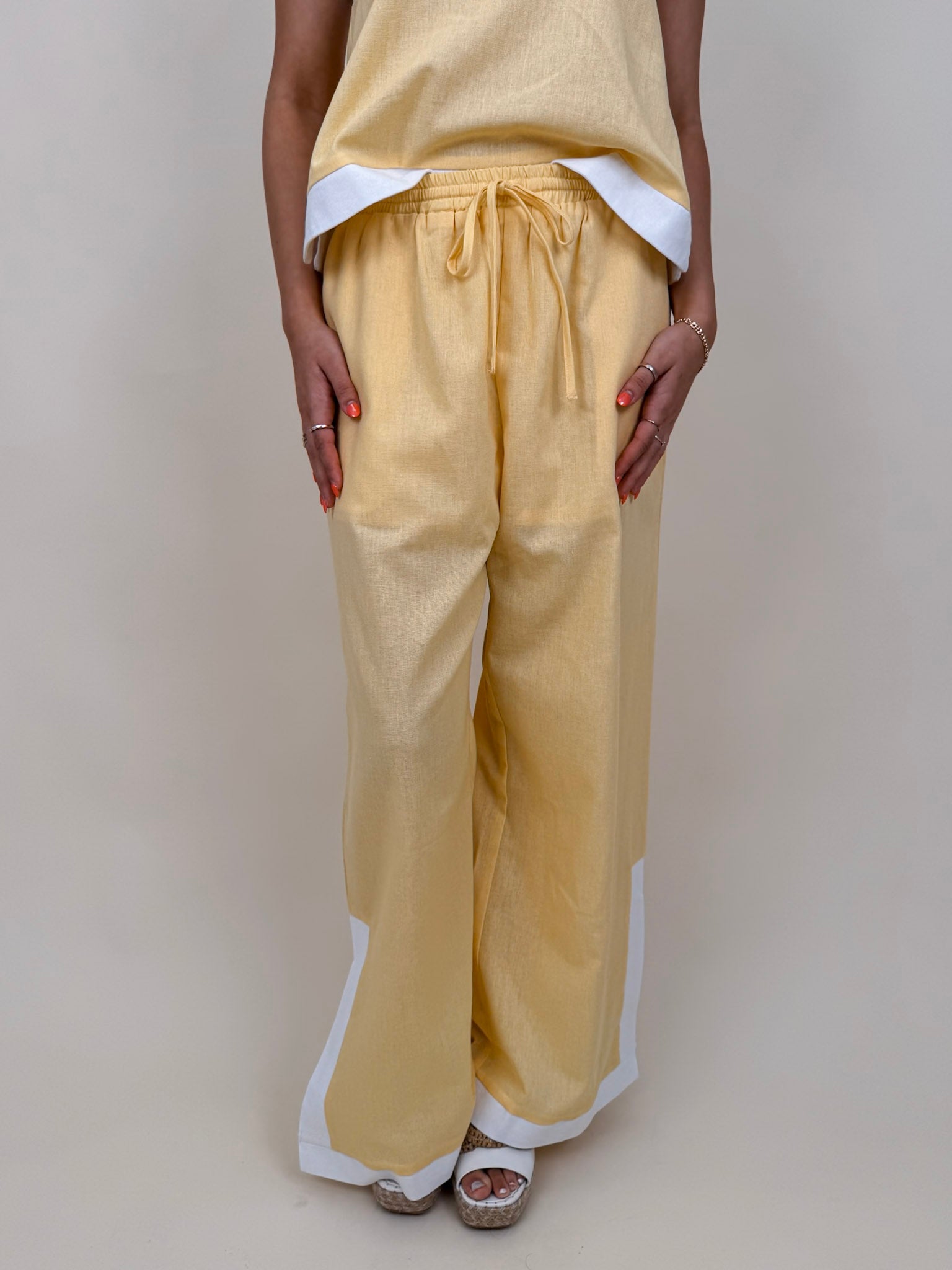 Walking At Sunset Top in lemon yellow with cross-halter neckline and white contrast trim — Paper Doll
