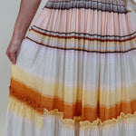 Sunset Tiered Maxi Skirt in an ombré sunset stripe of peach, gold, and rust — Paper Doll
