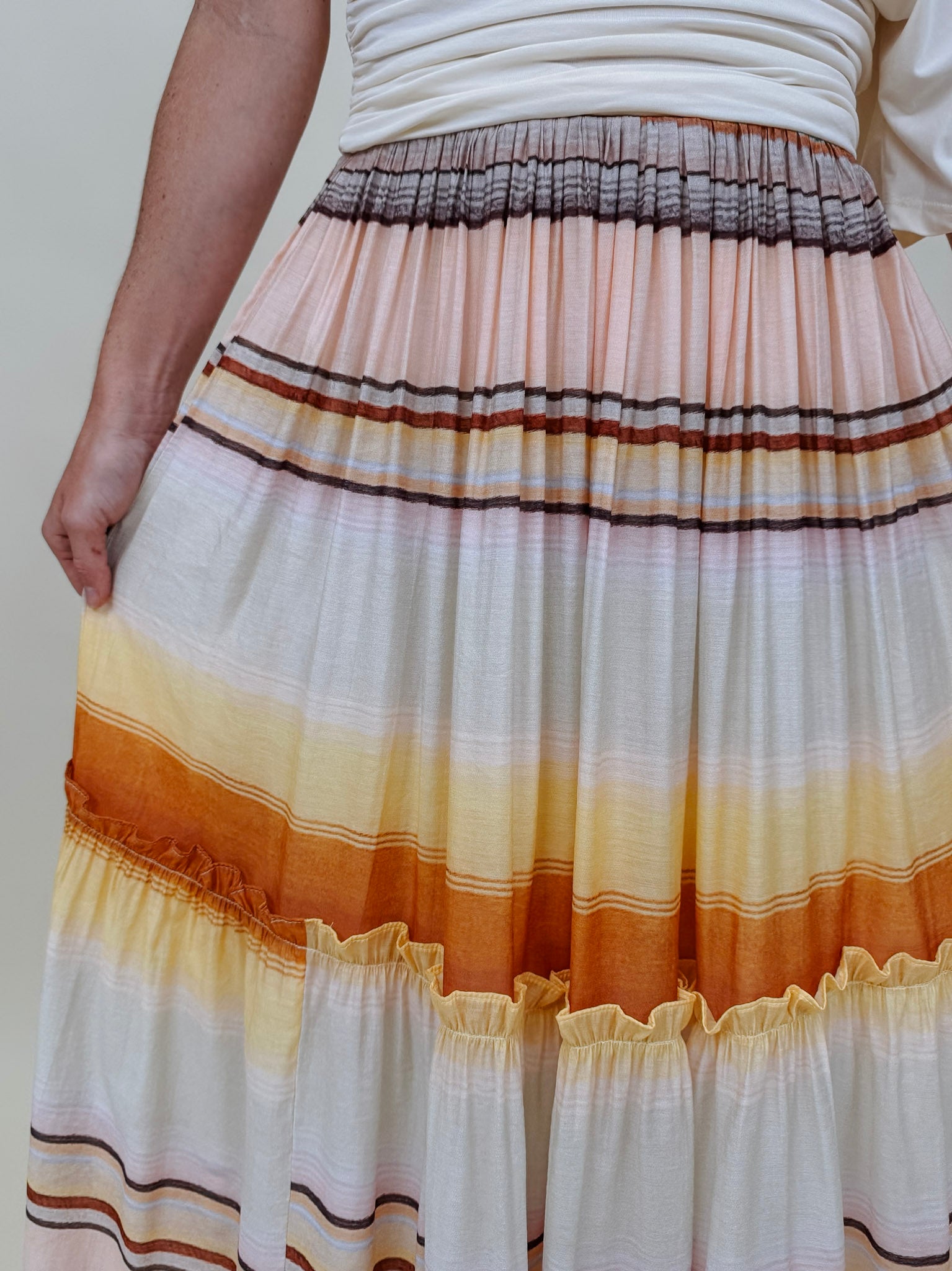 Sunset Tiered Maxi Skirt in an ombré sunset stripe of peach, gold, and rust — Paper Doll
