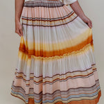 Sunset Tiered Maxi Skirt in an ombré sunset stripe of peach, gold, and rust — Paper Doll
