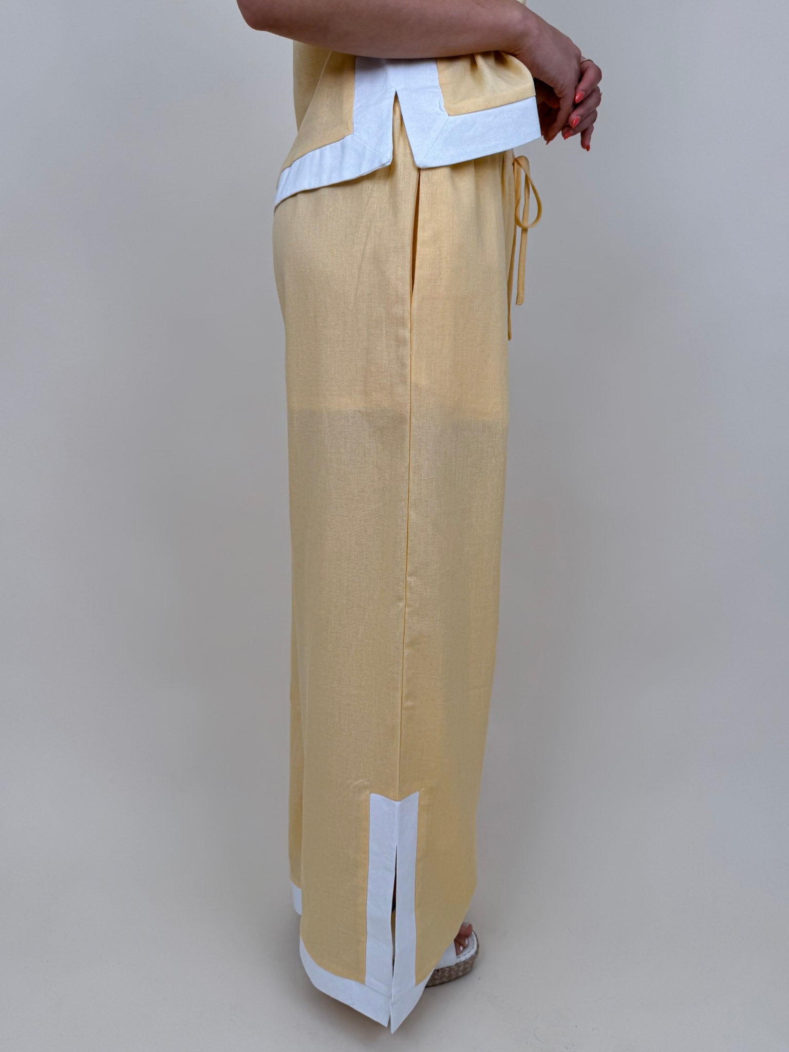 Walking At Sunset Top in lemon yellow with cross-halter neckline and white contrast trim — Paper Doll
