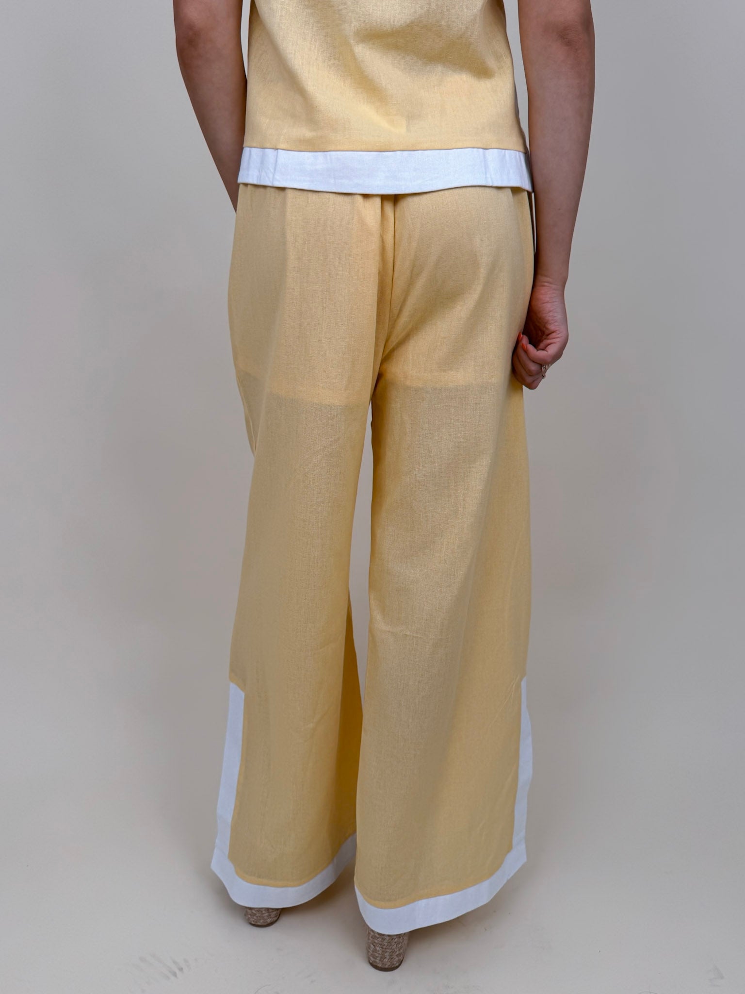 Walking At Sunset Top in lemon yellow with cross-halter neckline and white contrast trim — Paper Doll
