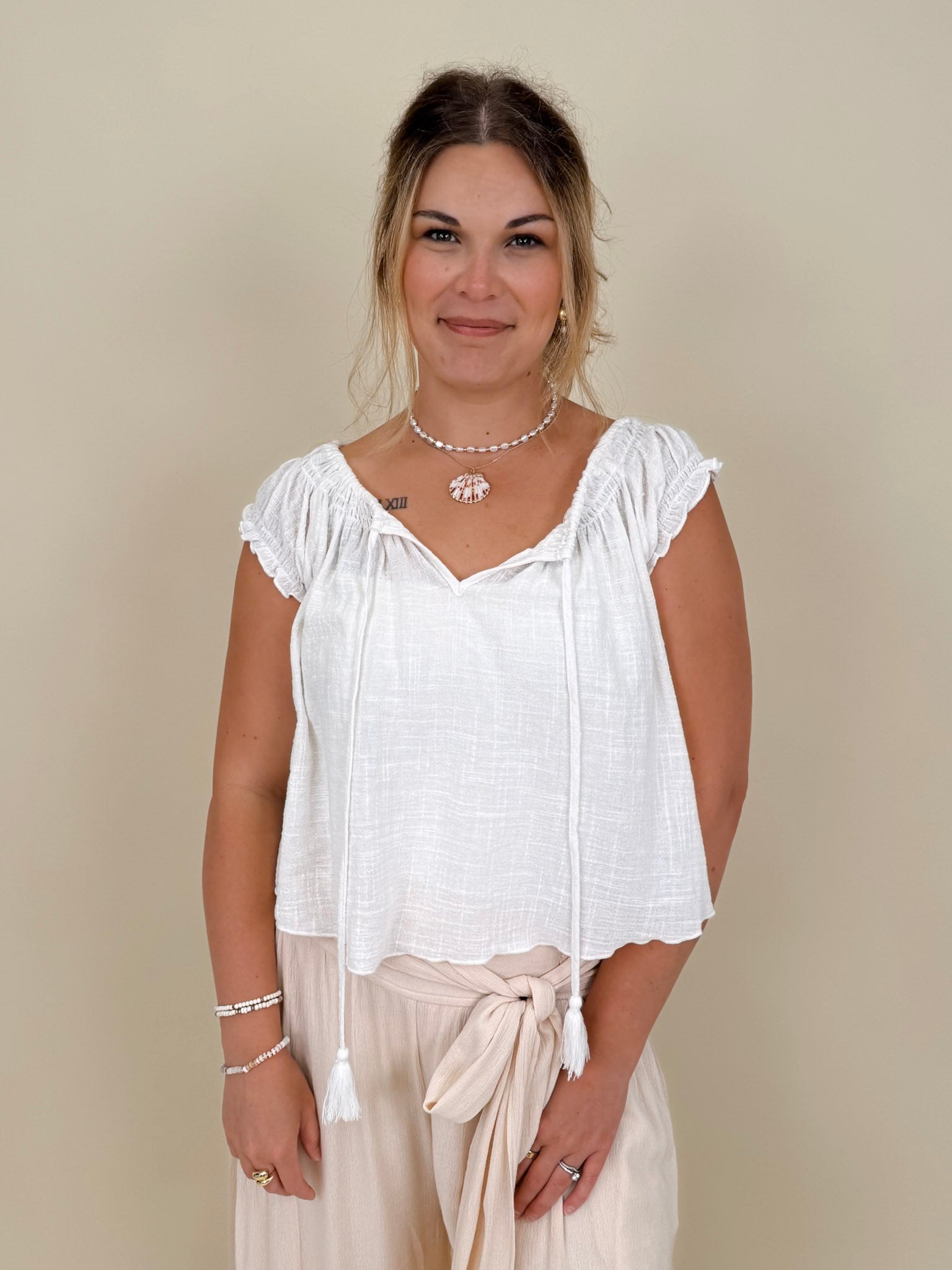 Hadleigh Smocked Neckline Blouse in white with tie neckline and flutter sleeves — Paper Doll