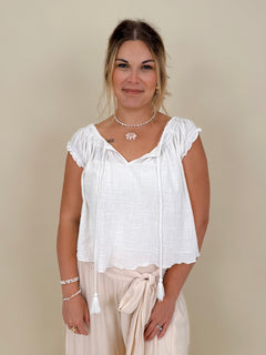 Hadleigh Smocked Neckline Blouse in white with tie neckline and flutter sleeves — Paper Doll