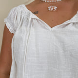 Hadleigh Smocked Neckline Blouse in white with tie neckline and flutter sleeves — Paper Doll