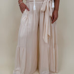 Evanthe Tie-Waist Wide Leg Pants in cream with tiered wide-leg and tassel tie — Paper Doll
