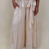 Evanthe Tie-Waist Wide Leg Pants in cream with tiered wide-leg and tassel tie — Paper Doll