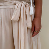 Evanthe Tie-Waist Wide Leg Pants in cream with tiered wide-leg and tassel tie — Paper Doll