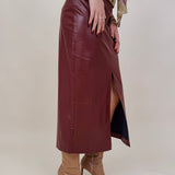 Hailey Midi Skirt in burgundy faux leather with front slit — Paper Doll