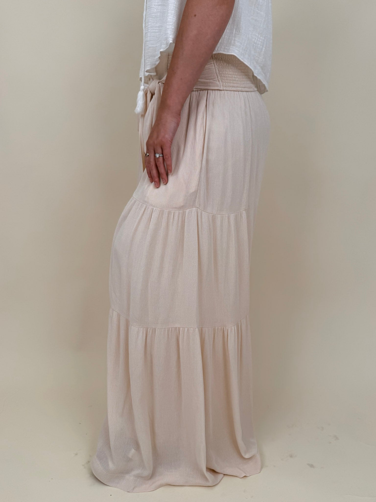 Evanthe Tie-Waist Wide Leg Pants in cream with tiered wide-leg and tassel tie — Paper Doll