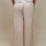 Evanthe Tie-Waist Wide Leg Pants in cream with tiered wide-leg and tassel tie — Paper Doll