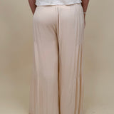 Evanthe Tie-Waist Wide Leg Pants in cream with tiered wide-leg and tassel tie — Paper Doll