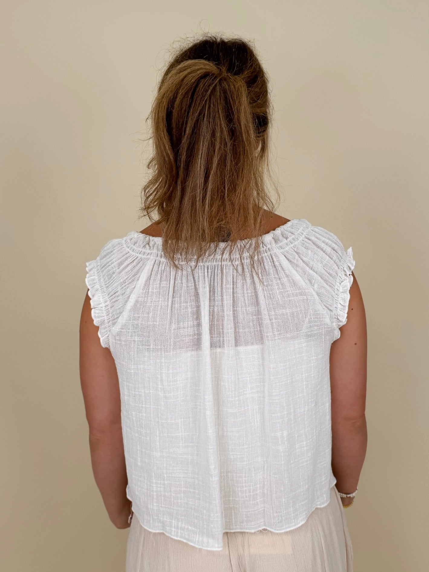 Hadleigh Smocked Neckline Blouse in white with tie neckline and flutter sleeves — Paper Doll