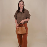 Belle Plaid Button Up Top in chocolate brown and cream windowpane plaid with covered buttons, a ruffled collar, and cuffed short sleeves