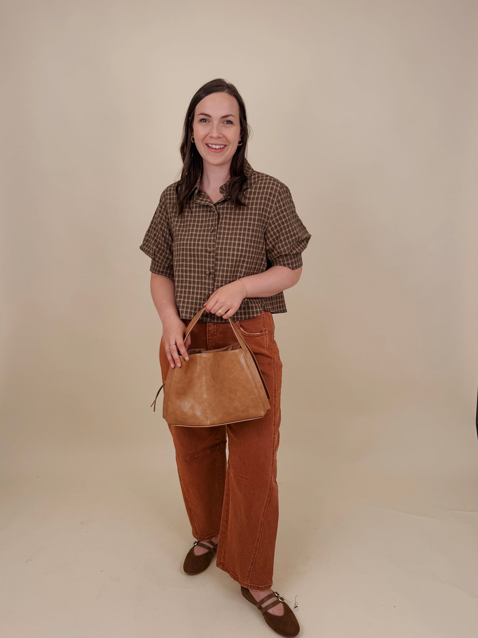 Belle Plaid Button Up Top in chocolate brown and cream windowpane plaid with covered buttons, a ruffled collar, and cuffed short sleeves