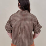 Belle Plaid Button Up Top in chocolate brown and cream windowpane plaid with covered buttons, a ruffled collar, and cuffed short sleeves