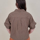 Belle Plaid Button Up Top in chocolate brown and cream windowpane plaid with covered buttons, a ruffled collar, and cuffed short sleeves
