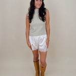 Blair Mock Neck Knit Top in soft light green with a textured rib knit, mock neckline, sleeveless cap shoulders, and a ribbed waist hem