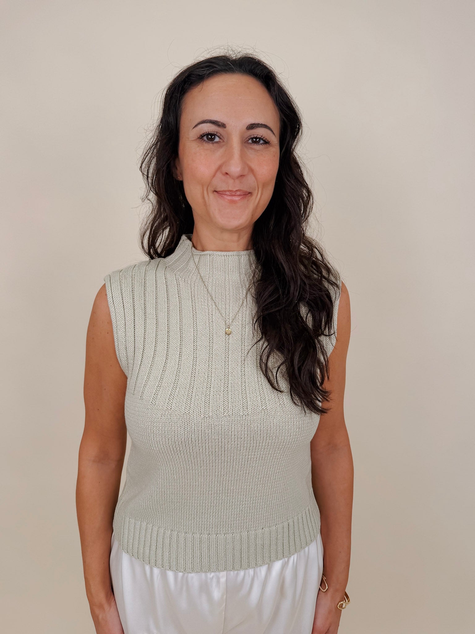 Blair Mock Neck Knit Top in soft light green with a textured rib knit, mock neckline, sleeveless cap shoulders, and a ribbed waist hem