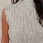 Blair Mock Neck Knit Top in soft light green with a textured rib knit, mock neckline, sleeveless cap shoulders, and a ribbed waist hem