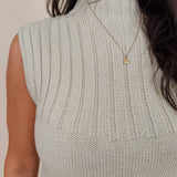 Blair Mock Neck Knit Top in soft light green with a textured rib knit, mock neckline, sleeveless cap shoulders, and a ribbed waist hem