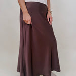 Juliette Satin Midi Skirt in chocolate brown with a smooth elastic waist and a bias cut silhouette that flares softly at the hem